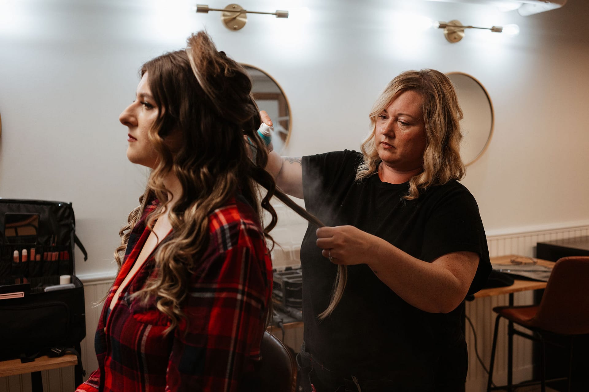 hair stylist hair spraying bride's hair