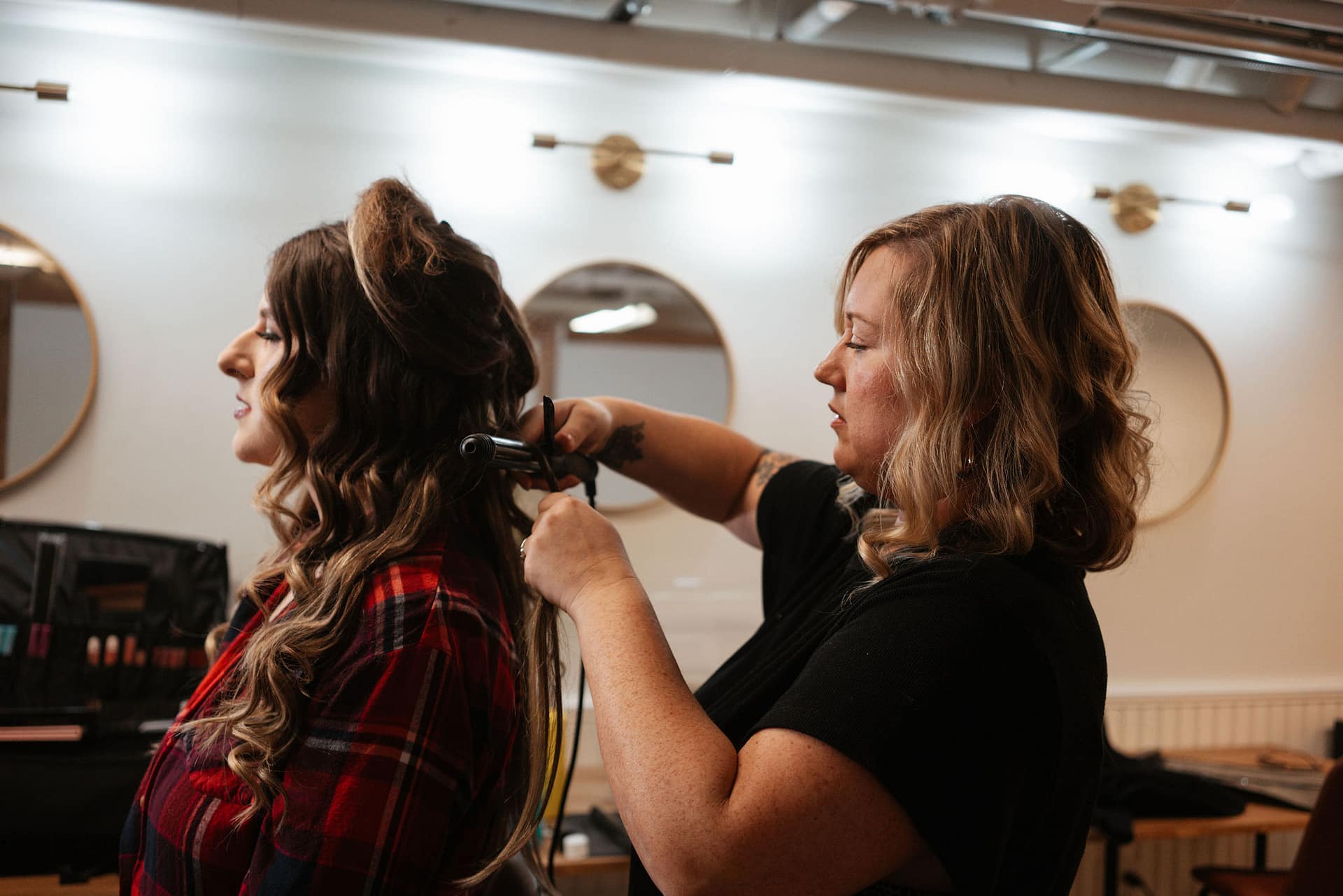 hair stylist curling bride's hair