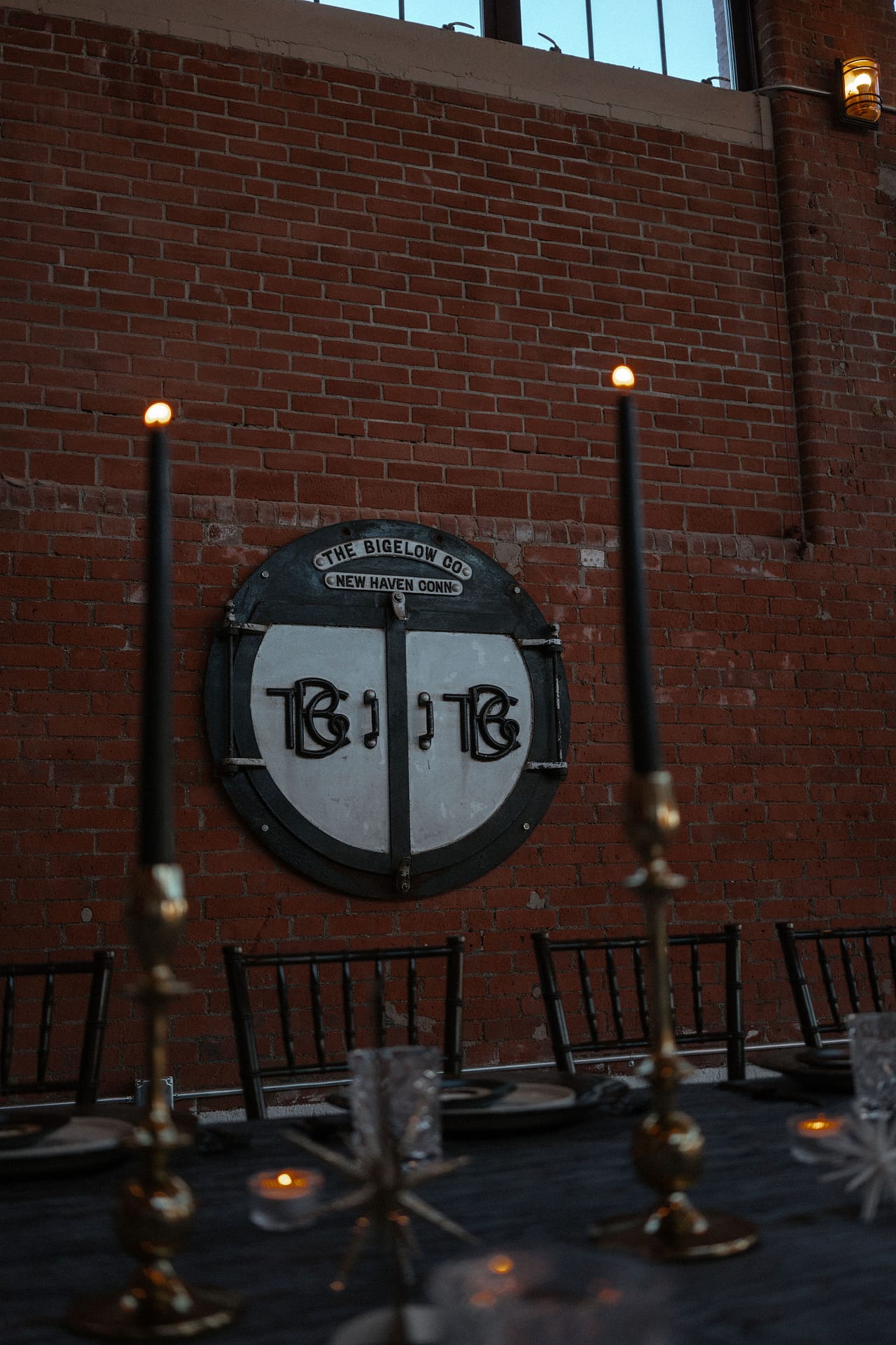 venue sign behind wedding reception tables