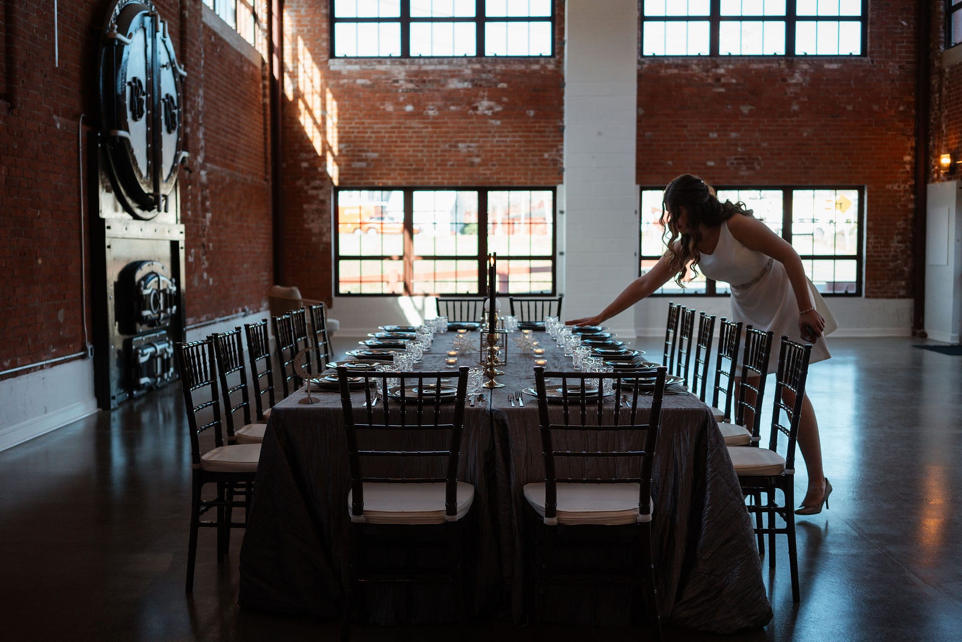 bride fixing wedding reception table