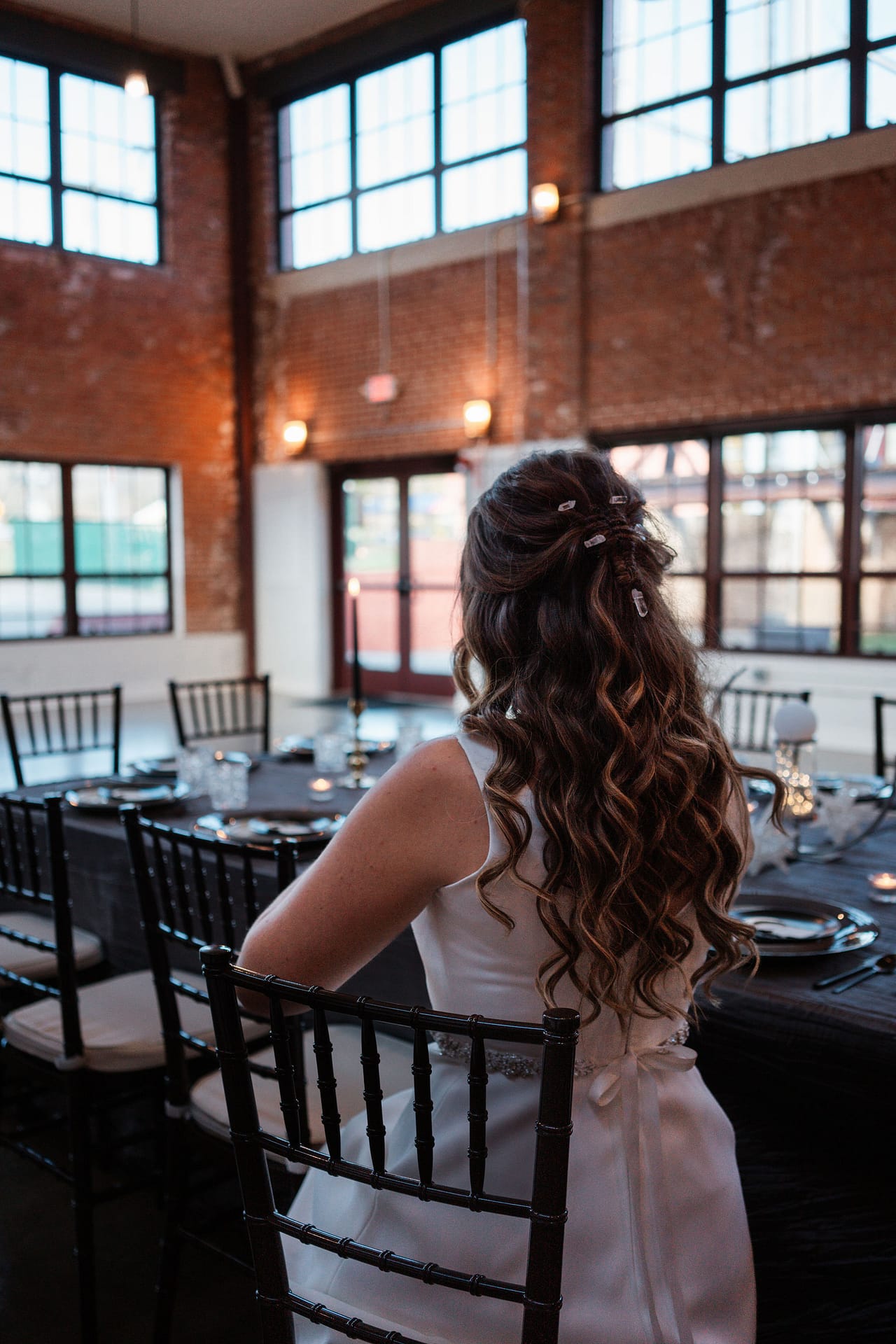 bride sitting at wedding reception tables