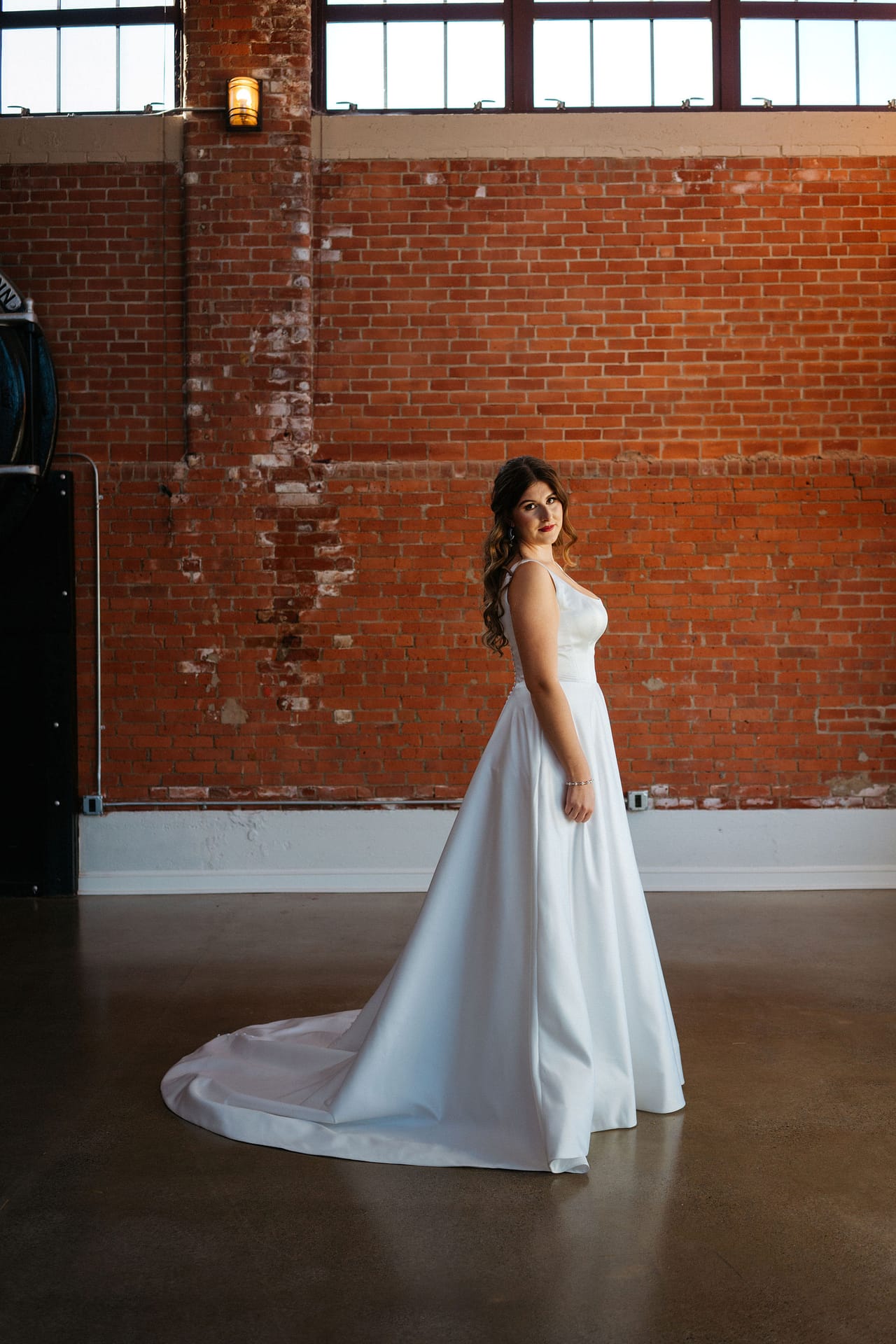 bride posing in brick venue