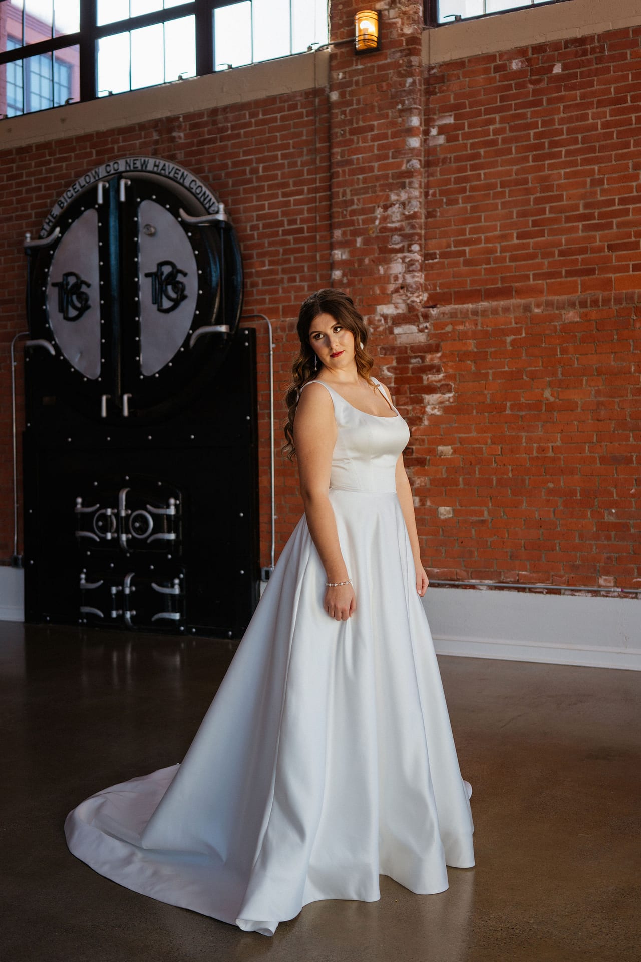 bride posing with venue sign