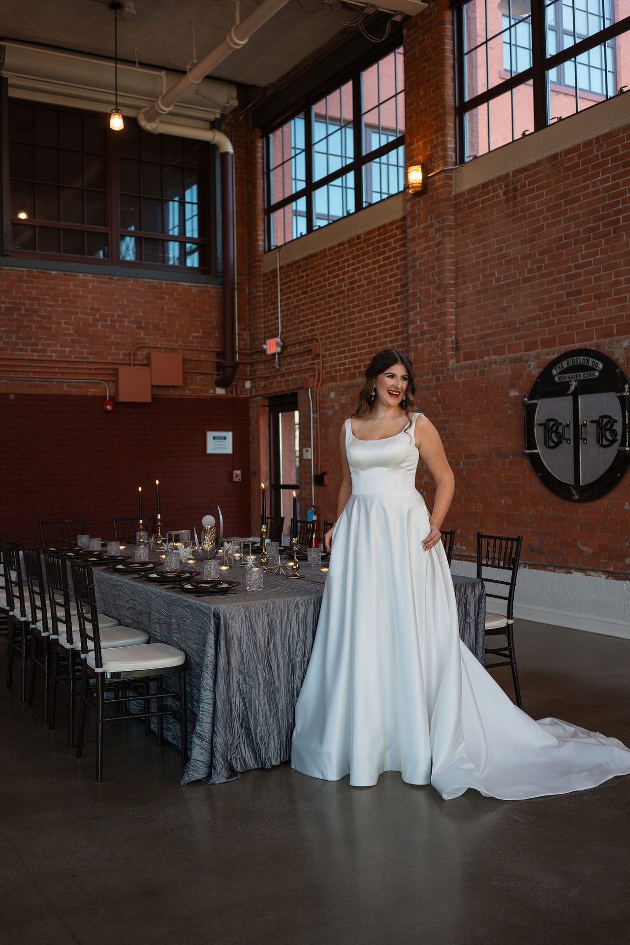 bride laughing in front of reception table