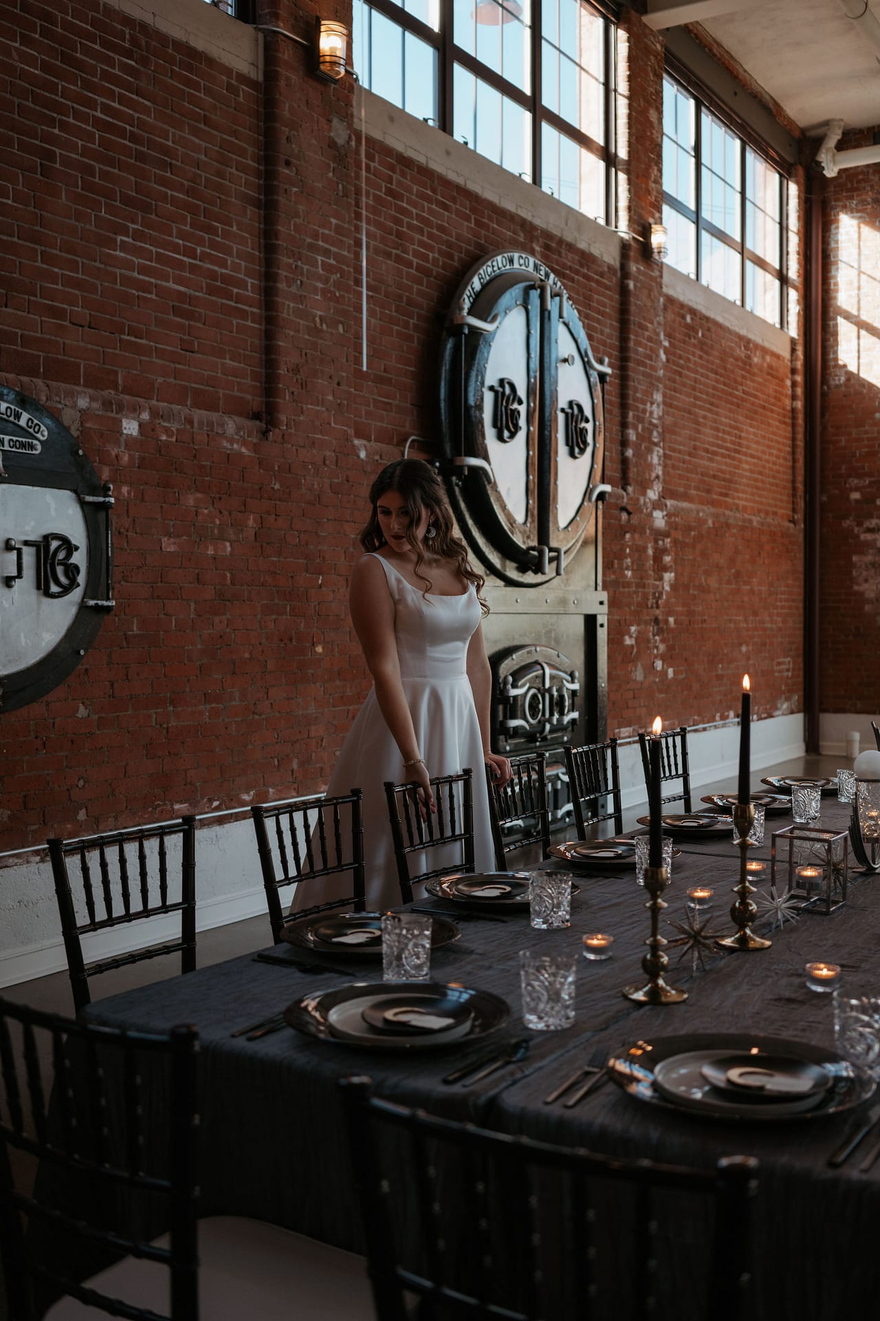 bride overlooking wedding reception tables