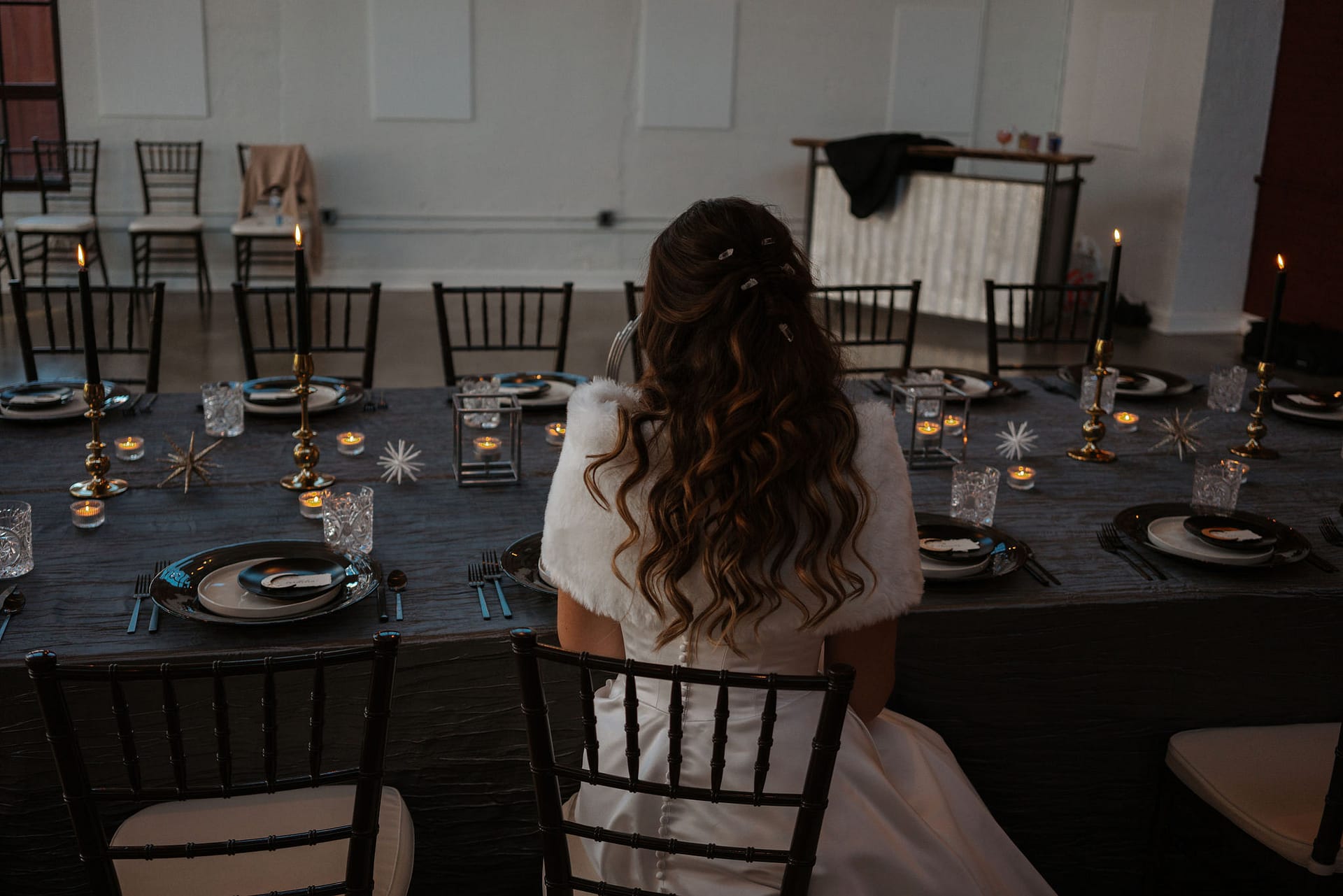 bride sitting at wedding reception tables