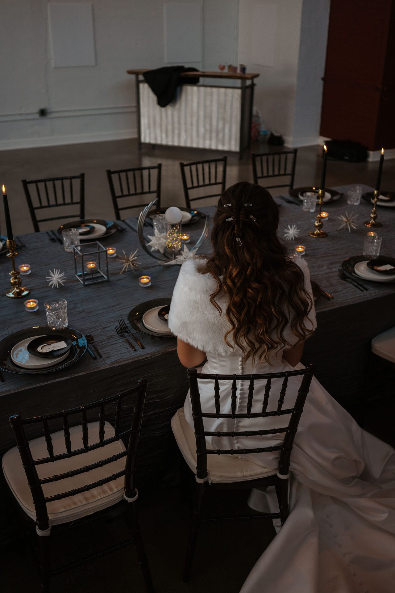 bride sitting at wedding reception tables with stars and moon theme