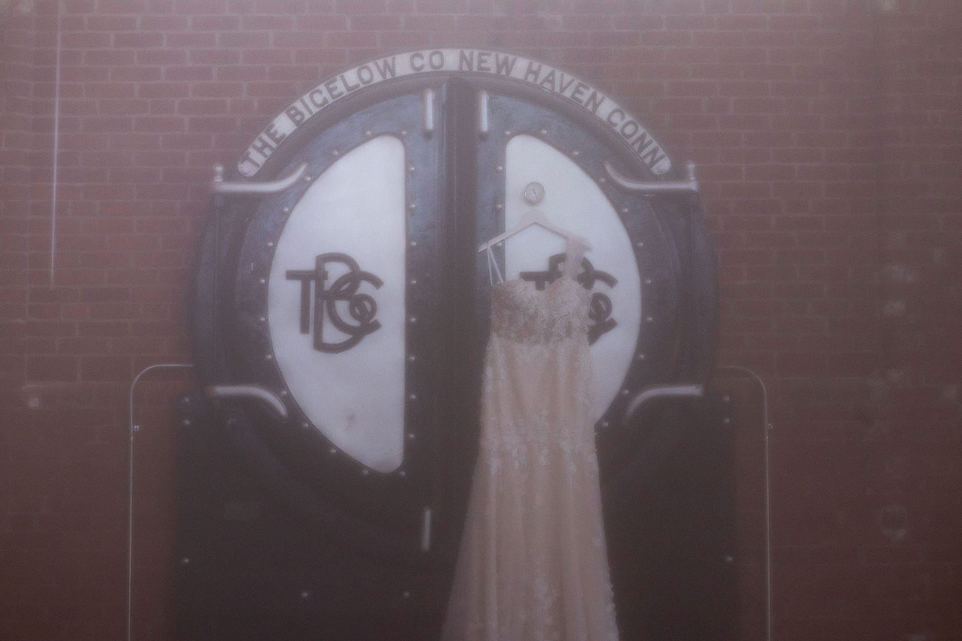 wedding dress hanging up on venue sign
